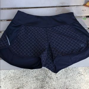 Athleta running shorts with reflective print